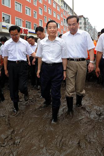 8月3日至4日,中共中央政治局常委、国务院总理温家宝在吉林省考察防汛抗洪工作。这是8月3日,在吉林市永吉县城,温家宝穿着胶鞋,踩着泥泞的道路察看灾情。